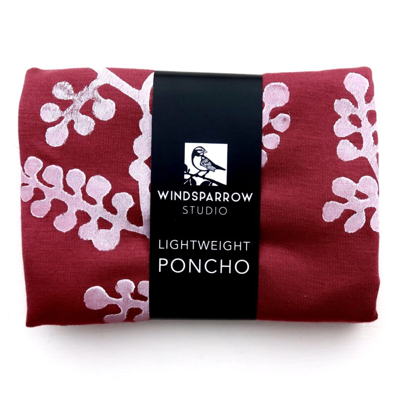 Berry Branch poncho (white ink) in packaging
